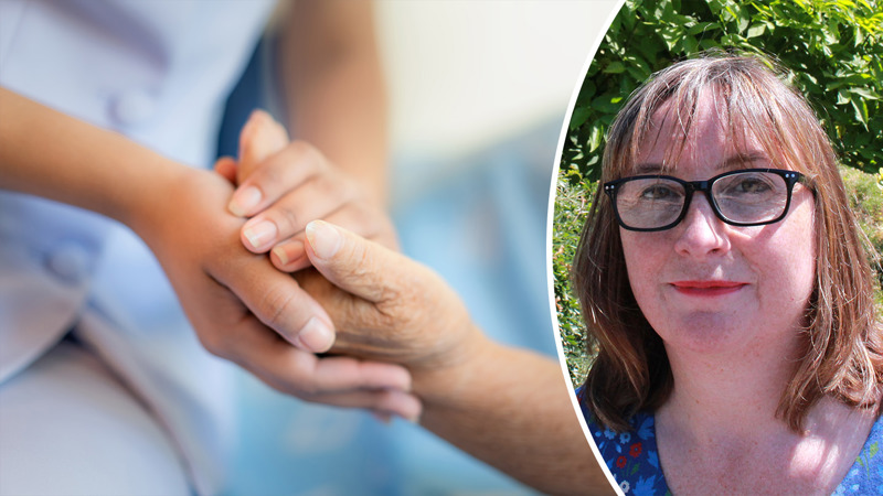 A nurse holding the hand of a patient