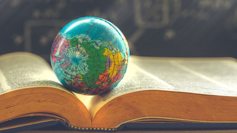 Globe resting in an open book