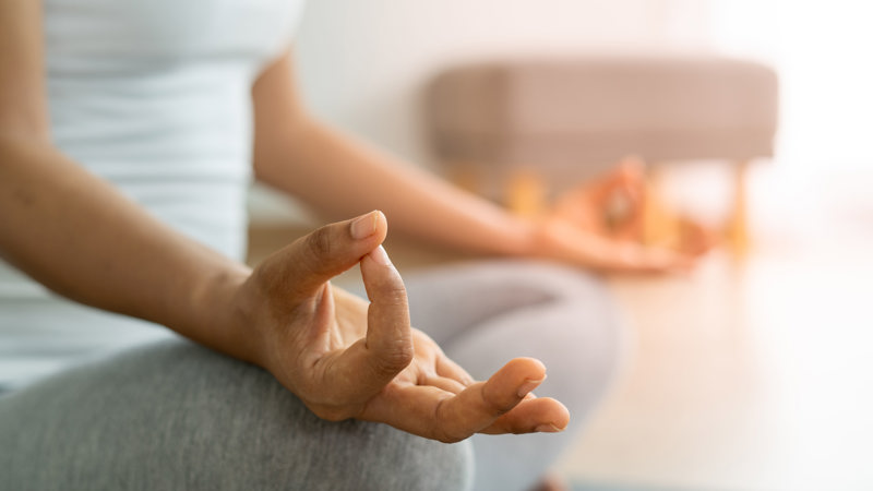 Person doing yoga with relaxing meditation positions