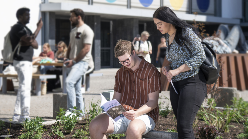 Two persons outside the University