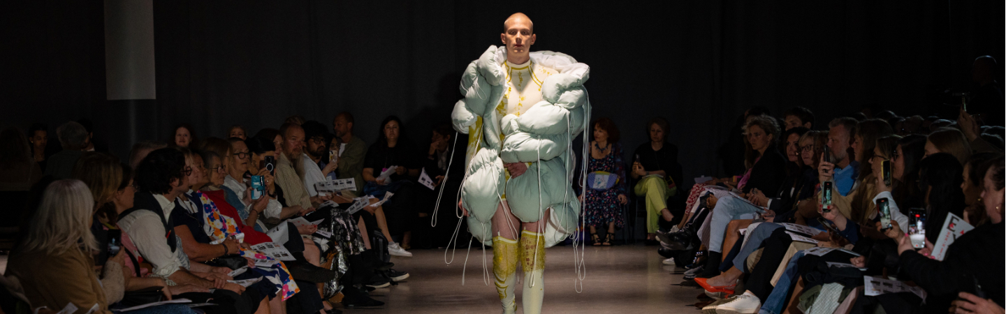 Male model walking down runway 